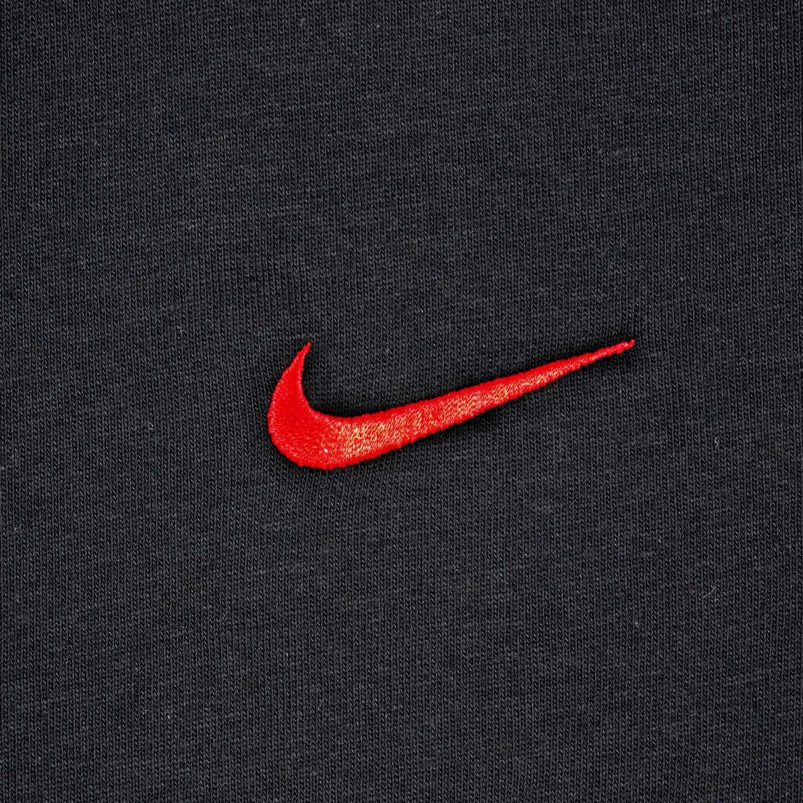 black nike top with red tick